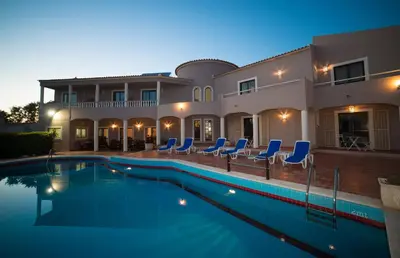 a villa with a swimming pool at night at Casa Rosa Montes in Luz