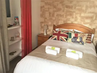 a bedroom with a bed with two pillows on it at Casa Amarela in Funchal