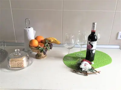 a bottle of wine and two glasses on a counter at Casa Amarela in Funchal