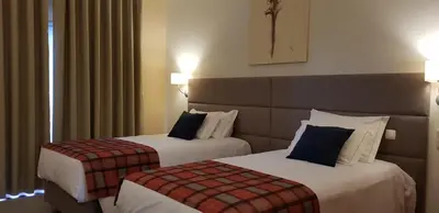 a hotel room with two beds in a room at Hotel O Colmo in Santana