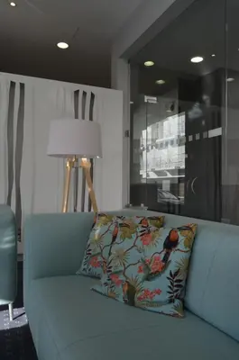 a blue couch with a pillow on it in a room at Madeira Bright Star by Petit Hotels in Funchal
