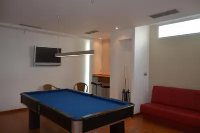 a living room with a pool table and a red couch at Madeira Bright Star by Petit Hotels in Funchal