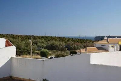 a view from the roof of a house with a white wall at Apartamentos e Quartos Atalaia in Sagres