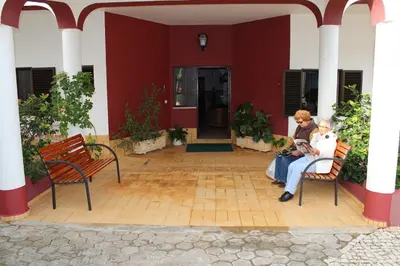 two women sitting on chairs on a patio at Apartamentos e Quartos Atalaia in Sagres