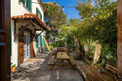 a room with two bunk beds and a rug at Jaca Hostel Porto da Cruz in Porto da Cruz