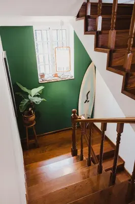 a room with two bunk beds and a ladder at Jaca Hostel Porto da Cruz in Porto da Cruz