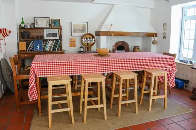 a bedroom with a large bed and a chandelier at Jaca Hostel Porto da Cruz in Porto da Cruz