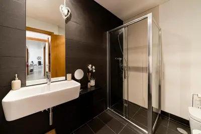a bathroom with a sink and a shower at Caniço VI by An Island Apart in Santa Cruz