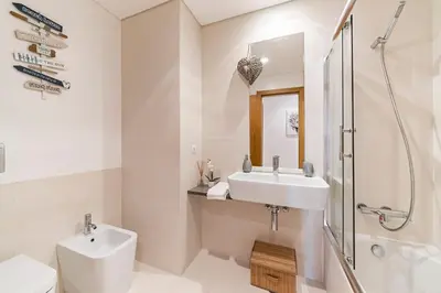 a white bathroom with a sink and a shower at Caniço VI by An Island Apart in Santa Cruz