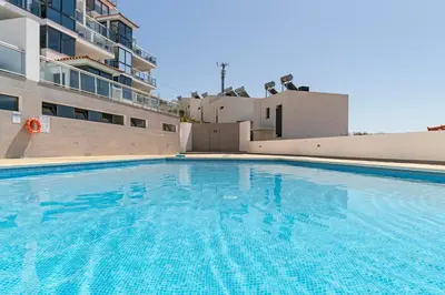 a large swimming pool in front of a building at Caniço VI by An Island Apart in Santa Cruz