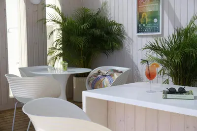 a hotel room with a bed and a desk with a television at Memmo Baleeira - Design Hotels in Sagres