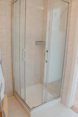 a shower with a glass door in a bathroom at Colina Mar in Funchal