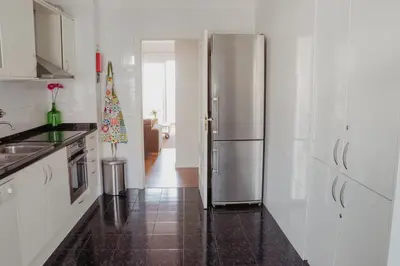 a kitchen with a stainless steel refrigerator and a christmas tree at Colina Mar in Funchal