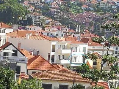 a group of houses with red roofs at Colina Mar in Funchal