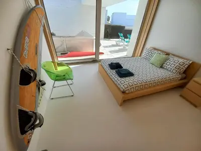 a small room with a bed and a window at Casa dos Pátios in Sagres