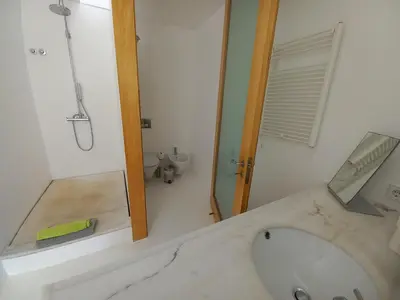 a bathroom with a tub and a sink and a shower at Casa dos Pátios in Sagres