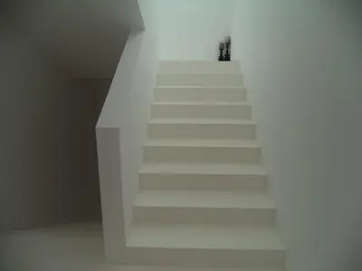 a stairway with white stairs in a room at Casa dos Pátios in Sagres