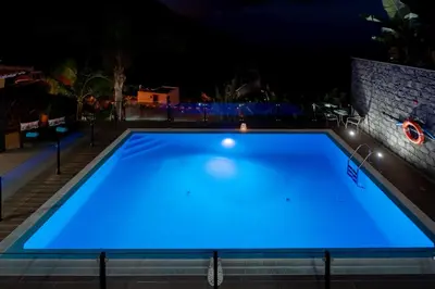 a swimming pool with a view of the ocean at Zeza´s house in Calheta