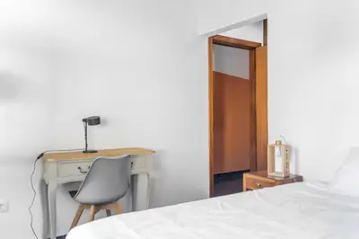 a bedroom with a desk and a bed and a chair at Cecília's House in Jardim do Mar