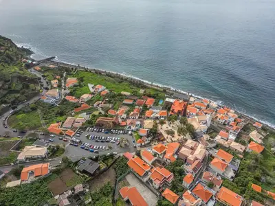 an aerial view of a town next to the ocean at Casa do Calhau in Jardim do Mar