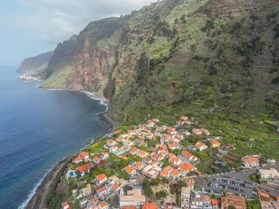 an aerial view of a village on the side of a mountain at Casa do Calhau in Jardim do Mar