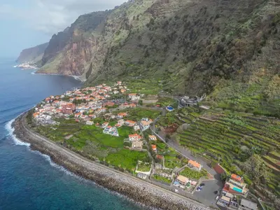 an aerial view of a village on the side of a mountain at Casa do Calhau in Jardim do Mar