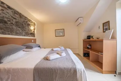 a bedroom with a large bed with towels on it at Casa do Calhau in Jardim do Mar