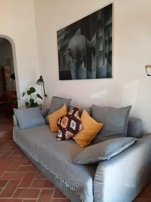 a couch with pillows on it in a living room at Casa Iemanjá in Vila do Bispo
