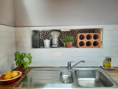a kitchen counter with a sink in a kitchen at Casa Iemanjá in Vila do Bispo