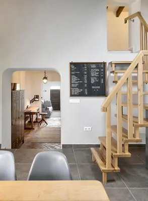 a dining room with a staircase and a table with chairs at Casa Iemanjá in Vila do Bispo