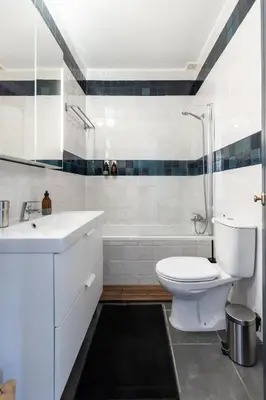 a bathroom with a toilet and a sink and a tub at Casa Iemanjá in Vila do Bispo