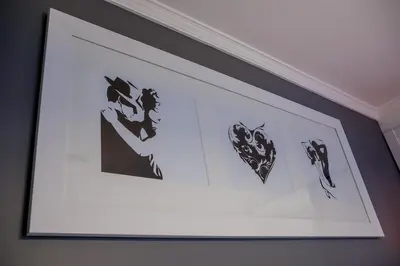 a framed picture on a wall with black and white pictures at Apartamento Boutique Ana Lúcia in Santa Cruz