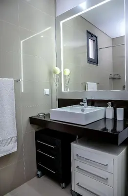 a bathroom with a sink and a large mirror at Apartamento Boutique Ana Lúcia in Santa Cruz