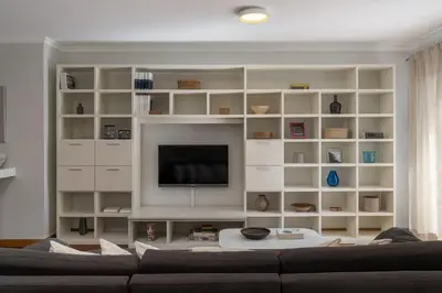 a living room with a couch and a tv at Arcadas III by An Island Apart in Funchal