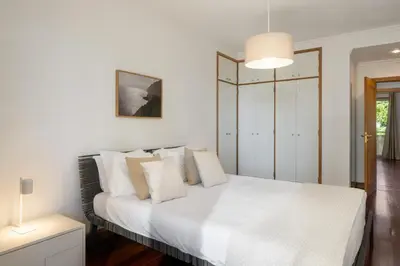 a bedroom with a white bed with white pillows at Arcadas III by An Island Apart in Funchal