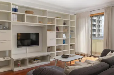 a living room with white shelves and a tv at Arcadas III by An Island Apart in Funchal