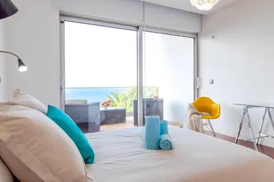 a bedroom with a bed with a view of the ocean at Villa Chimera By LovelyStay in Caniço