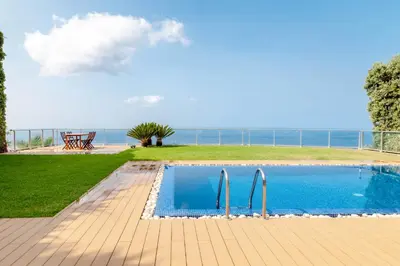 a swimming pool with a view of the ocean at Villa Chimera By LovelyStay in Caniço