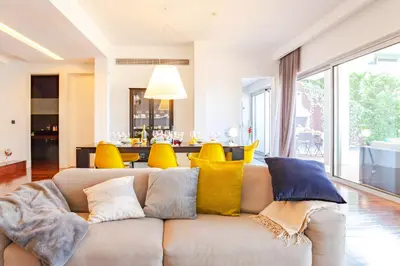 a living room with a couch with colorful pillows at Villa Chimera By LovelyStay in Caniço