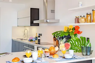 a kitchen with a table with glasses of orange juice at Villa Chimera By LovelyStay in Caniço