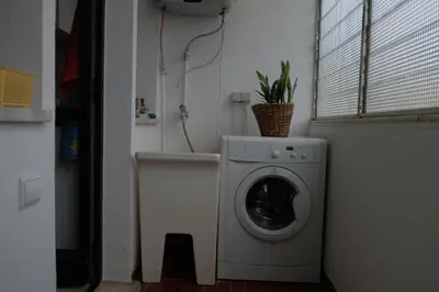 a bathroom with a shower curtain and a air conditioner at Lenamar in Funchal