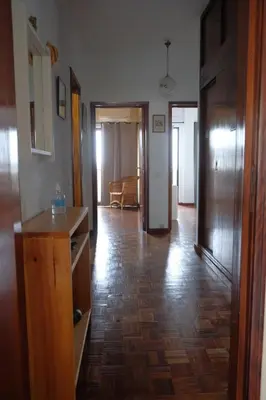 a living room with a wooden floor and a hallway at Lenamar in Funchal