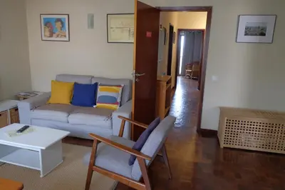 a living room with a couch and a table at Lenamar in Funchal