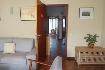 a living room with a tv and a table and chairs at Lenamar in Funchal