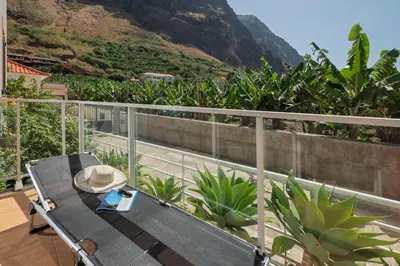 a hat sitting on a table on a balcony at Apartment Blue Sea in Paul do Mar