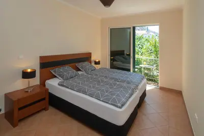a bedroom with a bed and a large window at Apartment Blue Sea in Paul do Mar