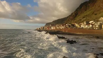 a view of a beach with waves and houses at Apartment Blue Sea in Paul do Mar