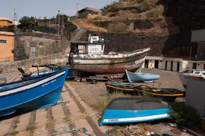 a group of boats sitting on the ground at Apartment Blue Sea in Paul do Mar