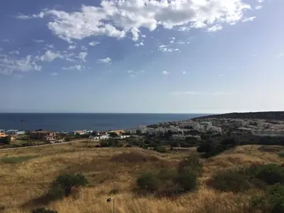 a view of a city and the ocean from a hill at Beach Condominium in Lagos