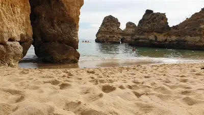 a sandy beach with some rocks in the water at Beach Condominium in Lagos